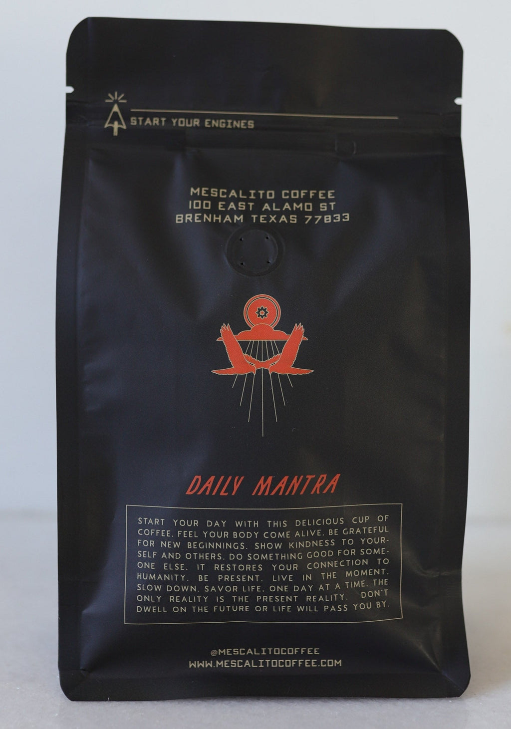 A black bag of Mescalito Coffee labeled "Blend Whole Coffee Beans | Kalimaz" features an address, a red illustration, and a paragraph highlighting Ethiopian Guji Kalimaz beans with extended fermentation for enhanced flavor.